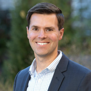 A photo of Professor Ryan Darr smiling at the camera